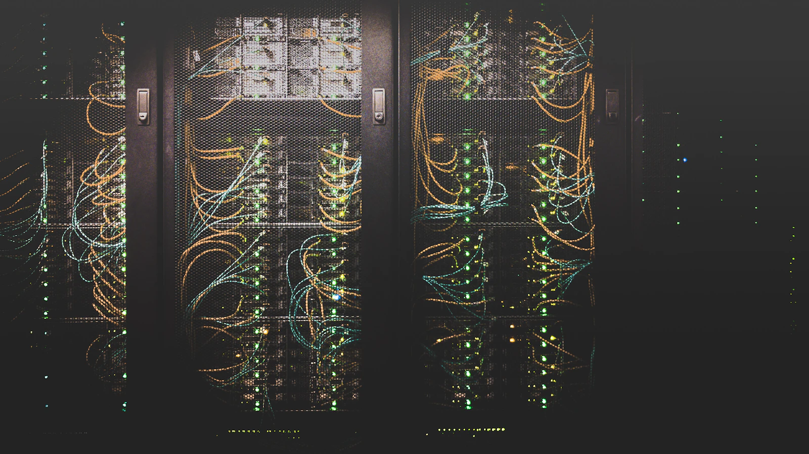 Server racks with cabling and status lights in a data center.