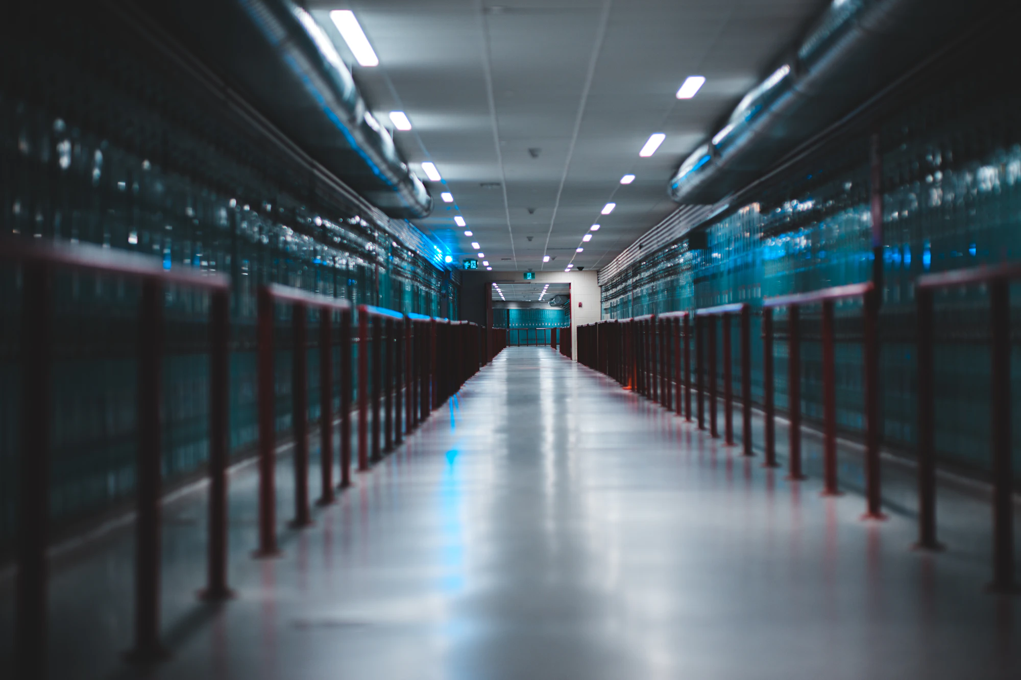 A lit aisle between rows of server cabinets.