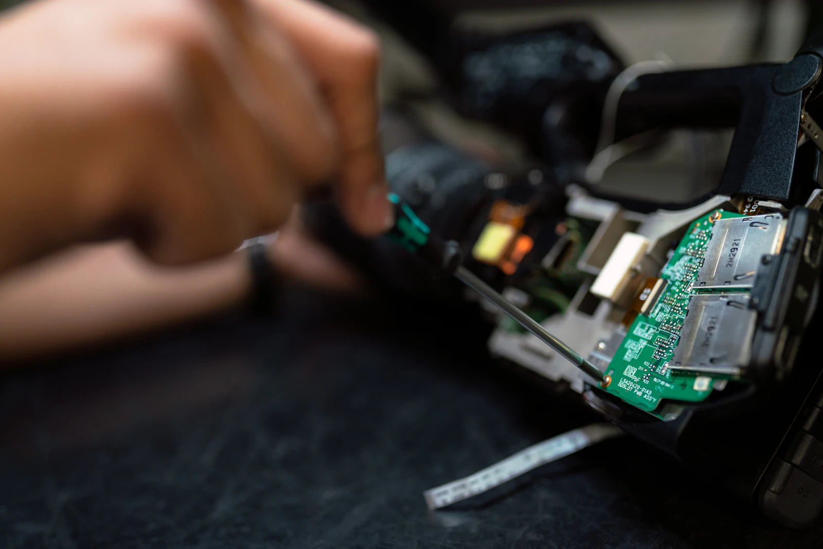 Engineer working hands-on with high-density electronics
